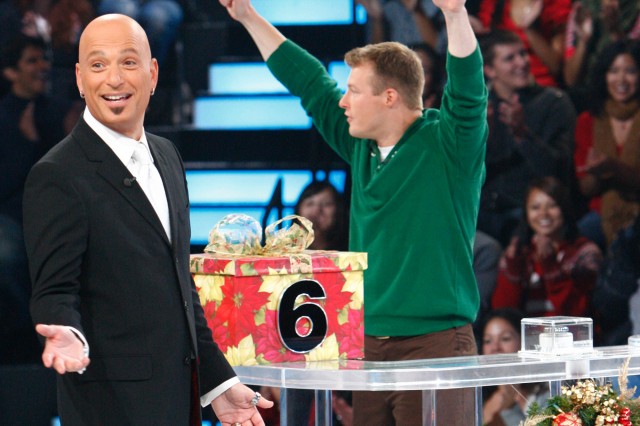 SSG Matt Zedwick celebrates with game show host Howie Mandel as he competes 