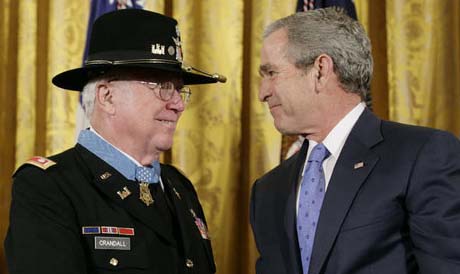Crandall with the Medal of Honor shakes hands with President George Bush, February 2007. Image from National Archives