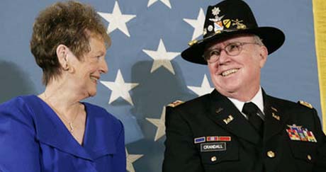 U.S. Army Major Bruce P. Crandall sits with his wife, Arlene, before the Medal of Honor flag in the East Room of the White House, Monday, Feb. 26, 2007, prior to Crandall being awarded the Medal of Honor for his extraordinary heroism as a 1st Cavalry helicopter flight commander in the Republic of Vietnam in November 1965. White House photo by Eric Draper