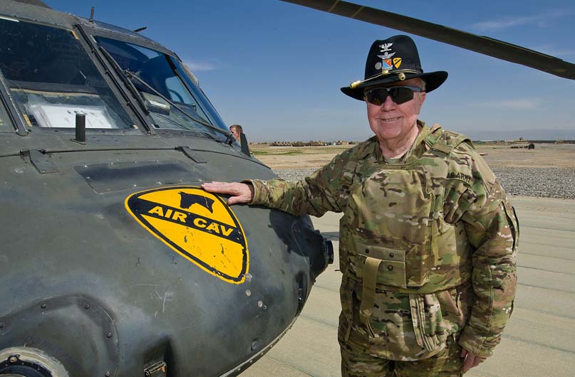 Retired Col. Bruce Crandall, a Medal of Honor recipient, poses for a picture with a UH-60 Black Hawk helicopter from Task Force Lobos, 1st Air Cavalry Brigade, 1st Cavalry Division March 28, 2012. Photo coutersy of DVIDS.