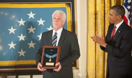 Ray Kapaun (left), nephew of Chaplain (Capt.) Emil J. Kapaun, accepted the Medal of Honor for his uncle, who was posthumously awarded the Medal of Honor during a ceremony in the East Room of the White House, Washington, D.C., April 11, 2013, as President Barack Obama applauds. (Photo Credit: U.S. Army)