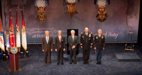 Ray Kapaun (center) prepares to accept the Medal of Honor citation and photo of his uncle, Chaplain (Capt.) Emil J. Kapaun as (from left) Secretary of Defense Chuck Hagel, Secretary of the Army John McHugh, Army Chief of Staff Gen. Raymond T. Odierno applaud and Sgt. Maj. of the Army Raymond F. Chandler III participates in the ceremony. (Photo Credit: U.S. Army)
