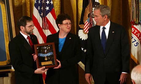 President George W. Bush shares a moment with Tom and Romayne McGinnis, of Knox, Pennsylvania, after presenting them the Congressional Medal of Honor in honor of their son, Private First Class Ross A. McGinnis, who was honored posthumously Monday, June 2, 2008, in the East Room of the White House. (White House photo by Joyce N. Boghosian)