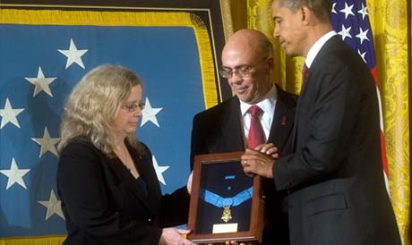 President Barack Obama presents the Medal of Honor posthumously to the parents of Staff Sgt. Robert J. Miller - father Phil, and mother Maureen Miller - Oct. 6, 2010, during a ceremony in the East Room of the White House in Washington. (Photo Credit: U.S. Army)
