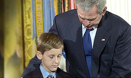President George W. Bush presents the Medal of Honor to David Smith, 11, April 4, 2005, at the White House. The militarys highest award was given to Smiths father Sgt. 1st Class Paul Ray Smith, 11th Engineer Battalion, 3rd Infantry Division, Fort Stewart, Ga., posthumously for his actions in the battle for Baghdad Airport. Photo courtesy of DVIDS.