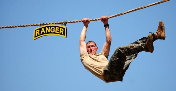 Soldier crossing overhead on a rope