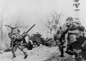 German troops advancing past abandoned American equipment