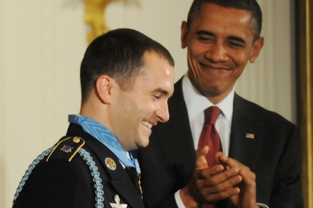 President Barack Obama applauds Staff Sergeant Giunta