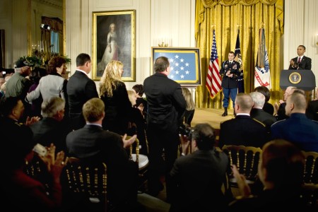 President Barack Obama applauding the family