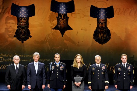 Staff Sergeant Salvatore Giunta, his wife, and others on stage