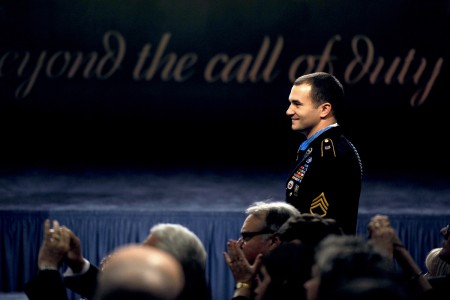 Staff Sergeant Salvatore Giunta walks in to Pentagon Hall of Heroes induction ceremony