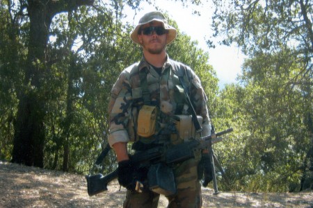 Staff Sergeant Robert Miller standing in the woods with his uniform on