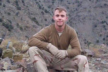 Staff Sergeant Robert Miller sitting in mountains of Afghanistan