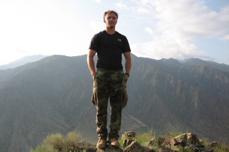 Staff Sergeant Robert Miller standing on top of a mountain