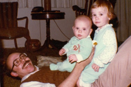 Staff Sergeant Robert Miller and sister sitting on their father as children