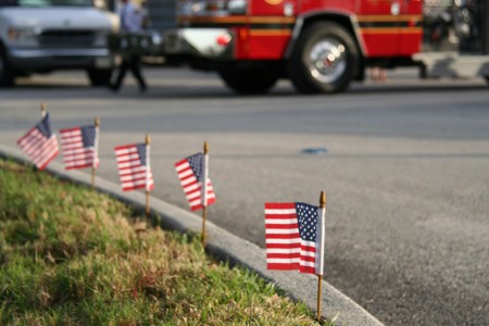 Small American flags at the curb