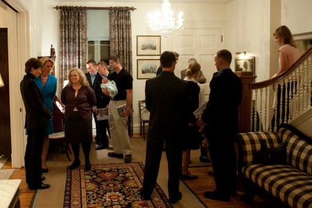 People standing around in the front hall of the house