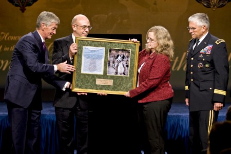 Staff Sergeant Robert Miller Medal of Honor's parents with a framed photo and citation