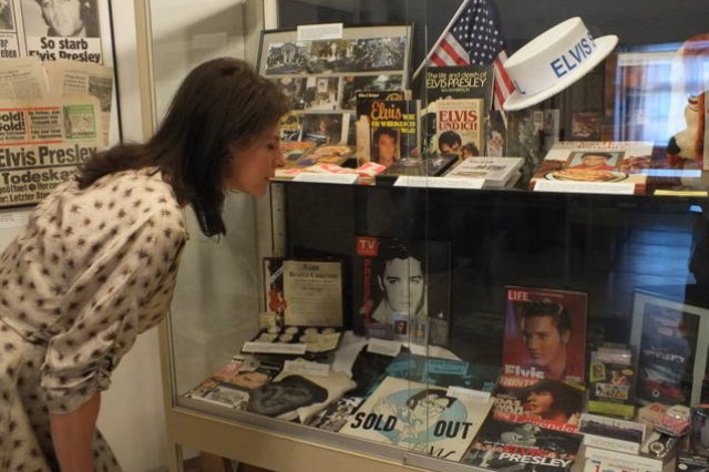 A visitor peruses a case full of Elvis memorabilia at the folk museum in Burglengenfeld, May 11.