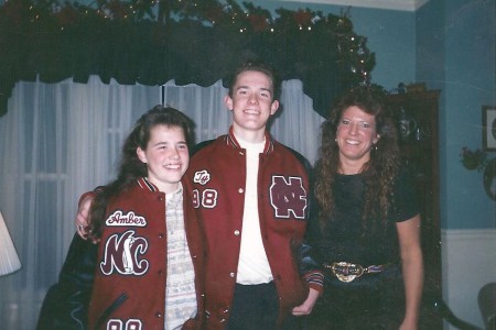 A young Ty Carter and his sister, Amber, try on letterman jackets, a gift from their maternal grandparents, on Christmas day in 1997.