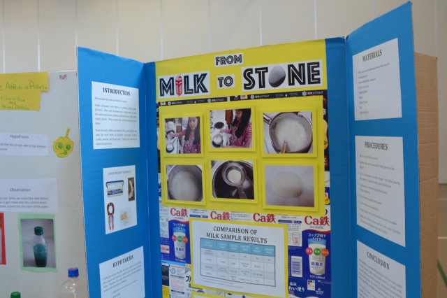 Perri Furnei, a fifth-grader from Arnn Elementary School, project titled "From Milk to Stone," hypothesizes the Casein protein in milk samples mixed with acid can hardening to the point of stone. Perri presented her experiment during the school's annual science fair April 17 held inside the school's gymnasium.  (U.S. Army photos by Candateshia Pafford)