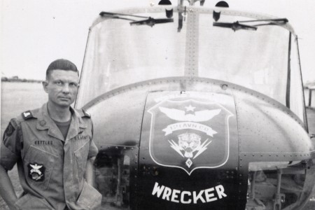 Maj. Charles Kettles stands in front of a 121st Aviation Company, UH-1H helicopter, during his second tour of duty in Vietnam in 1969. During his first tour with the 176th Aviation Company in May 1967, Kettles saved eight Soldiers who had been left behind after an initial rescue mission. He then managed to pilot the severely overloaded helicopter to safety and will be awarded the Medal of Honor in a July White House ceremony.