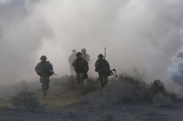 Soldiers assigned to 1st Battalion (attached to 1-2 Stryker Brigade Combat Team for training), 28th Infantry Regiment, 3rd Infantry Division, move under the cover of smoke during Decisive Action Rotation 16-06 at the National Training Center in Fort Irwin, Calif., May 16, 2016. The training focused on the 1-2 SBCT combating a near-peer enemy and smaller militant groups in a foreign country. 