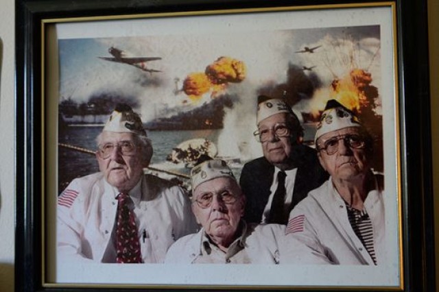 A photo of Bob McKenney (left), Richard Schimmel (center bottom), and two other Pearl Harbor survivors hangs in Schimmel's home office. DoD photo by Katie Lange
