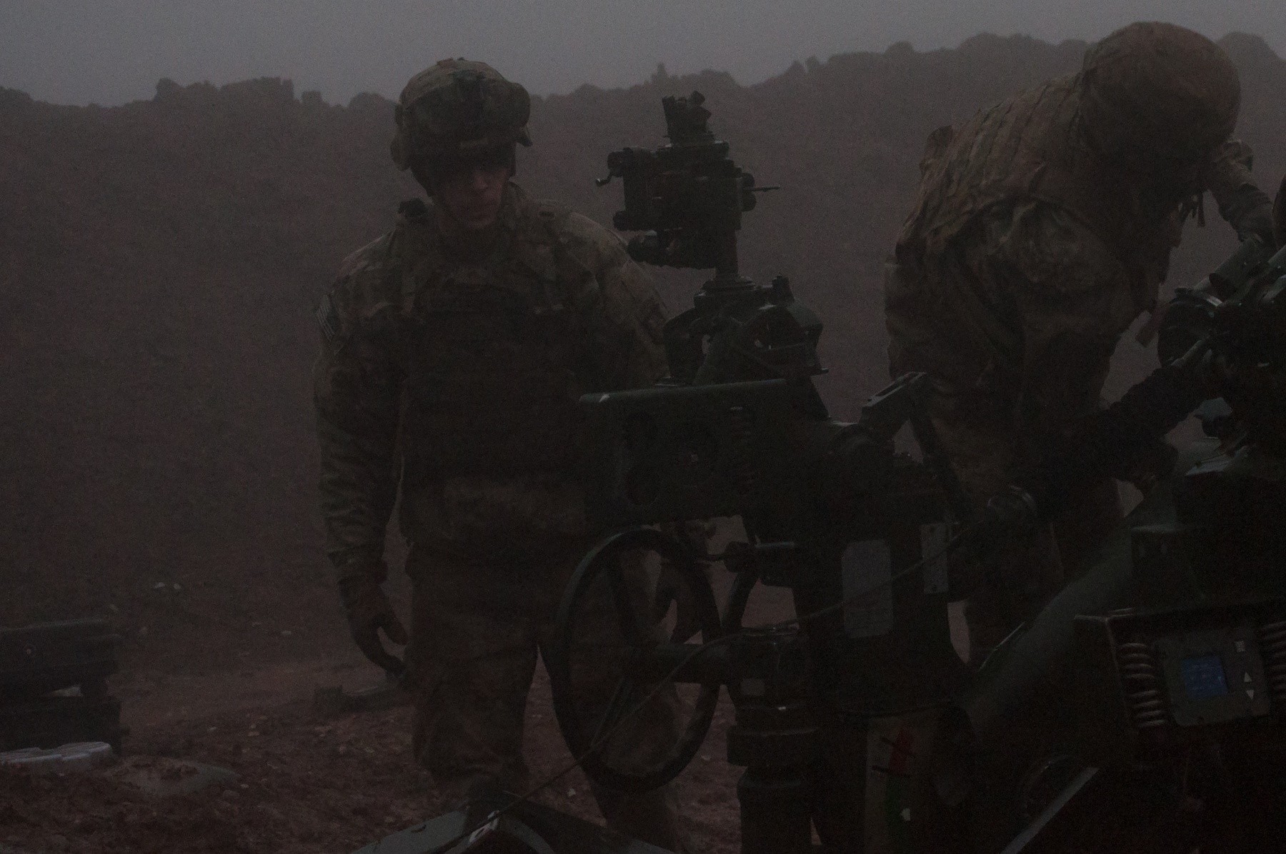U.S. Army Sgt. Scott Martineau, Battery C, 1st Battalion, 320th Field Artillery Regiment, Task Force Strike, moves towards his position on an M777 howitzer during a fire mission to support the security forces during the Mosul counteroffensive, Dec. 25, 2016, in northern Iraq. Battery C is supporting the ISF with indirect fires in their fight against ISIL. (Photo Credit: 1st Lt. Daniel Johnson)