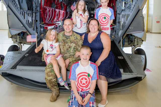 Rhiannon Knutson poses for a photo with her family on the back of a CH-47 Chinook helicopter. Knutson, who won the National Guard's military spouse of the year, and Cassaundra Martinez, who is representing the regular Army, are in the running with other branch winners to be called the 2017 Military Spouse of the Year. The winner, which was chosen by online voting earlier this month, will be announced May 12 at a ceremony in Washington, D.C.