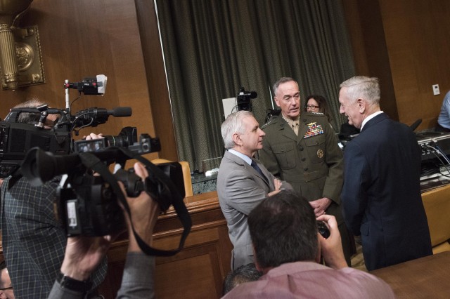 Defense Secretary Jim Mattis and Marine Corps Gen. Joe Dunford, chairman of the Joint Chiefs of Staff, speak with Rhode Island Senator Jack Reed at the Senate Appropriations Defense Subcommittee hearing on Capitol Hill, March 22, 2017.
