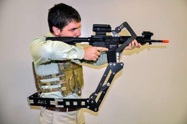 The Army Research Laboratory is developing a "third arm" passive mechanical appendage that could lessen Soldier burden and increase lethality. Weighing less than 4 pounds, the device attaches to a Soldier's protective vest and holds their weapon, putting less weight on their arms and freeing up their hands to do other tasks.