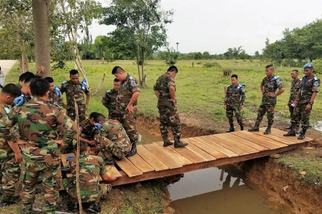 Members of the Royal Cambodian Armed Forces build a bridge in Kampong Speu Province, Cambodia, during a Subject Matter Expert Exchange with members of the Idaho National Guard, Sept. 12 to 24. The exchange is part of the National Guard's State Partnership Program, which facilitates the sharing of ideas, capabilities and experiences between guardsmen and host countries. The two organizations worked together to build three bridges that now serve Cambodian soldiers and citizens as useful pathways over ditches and wet gaps.