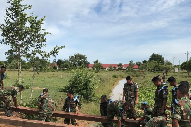 Members of the Royal Cambodian Armed Forces build a bridge in Kampong Speu Province, Cambodia, during a Subject Matter Expert Exchange with members of the Idaho National Guard, Sept. 12 to 24. The exchange is part of the National Guard State Partnership Program, which facilitates the sharing of ideas, capabilities and experiences between guardsmen and host countries. The two organizations worked together to build three bridges that now serve Cambodian soldiers and citizens as useful pathways over ditches and wet gaps.