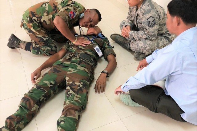 Master Sgt. Virginia Holmgren, a member of the Idaho Air National Guard, conducts first aid familiarization with a member of the Royal Cambodian Armed Forces during a Subject Matter Expert Exchange in Kampong Speu Province, Cambodia, Sept. 12 to 24. The exchange, was part of the National Guard State Partnership Program, which facilitates the sharing of ideas, capabilities and experiences between guardsmen and host countries.