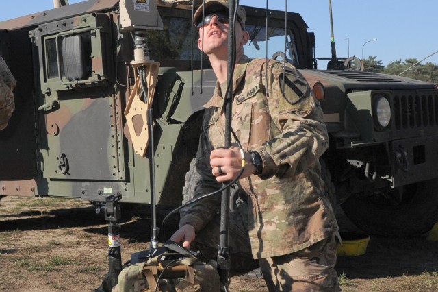 U.S. Army Staff Sgt. Michael Deremain, an electronic warfare specialist assigned to Headquarters and Headquarters Company, 1st Armored Brigade Combat Team, 1st Cavalry Division, assembles a VROD/VMAX backpack system at Zagan, Poland, Oct. 11, 2018. 