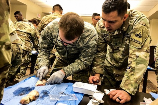 CAMP HUMPHREYS, Republic of Korea - 1st Lt. Armando Zavala, El Paso, Texas native, physician assistant, 4th Battalion, 6th Infantry Regiment, 3rd Armored Brigade Combat Team, 1st Armored Division (Rotational), uses suturing tools to  invent a  cleave in a pig's foot in preparation for stitching. (Courtesy U.S. Army photo by Sgt. 1st Class Yu Rhee, 3rd ABCT, 1st AD, Medical Operations NCO)