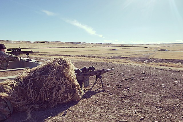 A test Sniper engages targets identified by his spotter while wearing a Ghillie suit during the Compact, Semi-Automatic Sniper Rifle (CSASS) operational test at Fort Carson, Colo.