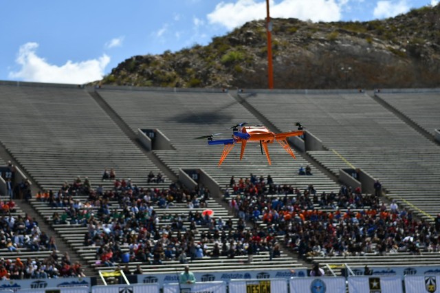 An unmanned aerial vehicle, flown by a team of undergraduate students from the University of Texas at El Paso, maneuvers the course during the U.S. Army's inaugural HBCU/MI Design Competition held at the University of Texas at El Paso's Sun Bowl Stadium April 23-24, 2019, as local high school students watch from the stands. Each team had ten minutes to complete a series of tasks with the UAV they designed and built for the competition.The competition, led by the U.S. Army Combat Capabilities Development Command, challenged 11 undergraduate student teams from historically black colleges and universities and other minority serving institutions (HBCUs/MIs) to develop solutions to real-world technical challenges faced by U.S. Army researchers in the area of unmanned aerial vehicles, commonly called drones.