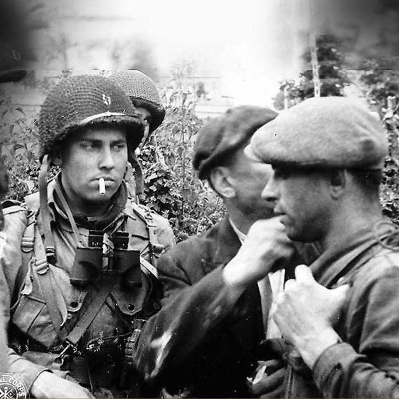 Capt. Kenneth Johnson of the 508th PIR, HQ Co - 82nd Airborne Division interrogates civilians in Ravenoville. French fighters gathered intelligence and assisted in preparation for the landings. Photo Courtesy of National Archives.