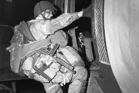 A fully equipped paratrooper boards an airplane that will drop him over the coast of Normandy for the Allied Invasion of Europe, D-Day, June 6, 1944.