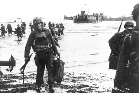 Carrying full equipment, American assault troops move onto Utah Beach on the northern coast of France.