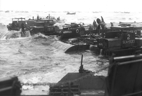 Three Rhino barges and a petrol barge are being hammered by surf.