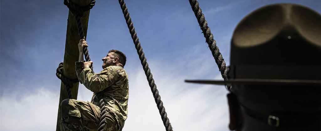 Soldier climbs obstacle