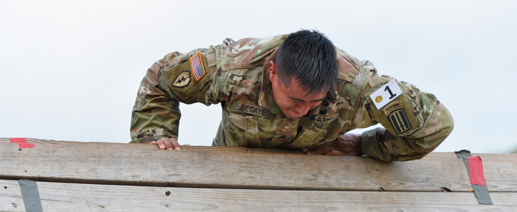 Soldier vaults over obstacle