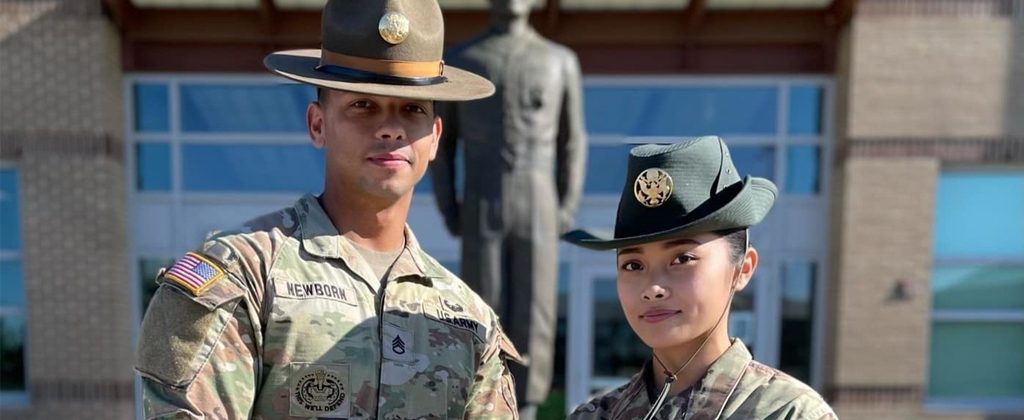 Two drill sergeants pose for a photo
