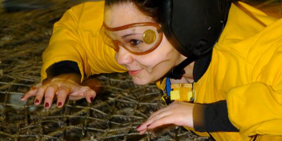 During a temporary assignment to Fort Bragg, N.C., Sarah Rivette, Army Public Affairs intern, takes a spin in the Jump Tower. Service members hone their freefall skills to prepare for actual missions.