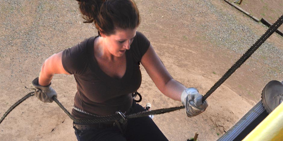 Former Army Intern, Samantha Reho rappels off a 40-foot tower as part of an installation tour she led for community civic leaders at Fort Bliss, Texas. Each participant met with Air Assault Soldiers who instructed them on training requirements from assembling the harness to proper technique when jumping.