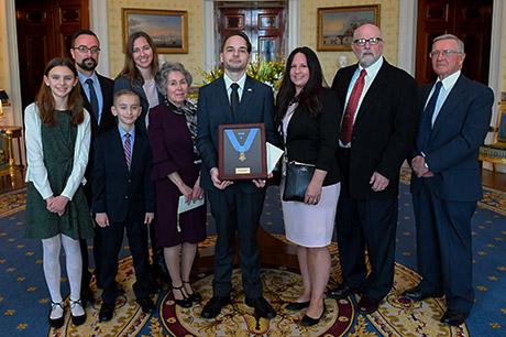 President Donald J. Trump posthumously awards the Medal of Honor to Staff Sgt. Travis W. Atkins at the White House in Washington D.C., March 27, 2019. Atkins was posthumously awarded the Medal of Honor for actions while serving with Delta Company, 2nd Battalion, 14th Infantry Regiment, 2nd Brigade Combat Team, 10th Mountain Division, in Abu Sarnak, Iraq, in support of Operation Iraqi Freedom, on June 1, 2007. His extraordinary heroism in attempting to subdue a suicide bomber and shielding three Soldiers from the imminent explosion resulted in him being mortally wounded and saving the Soldiers. (U.S. Army photo by Spc. James Harvey)