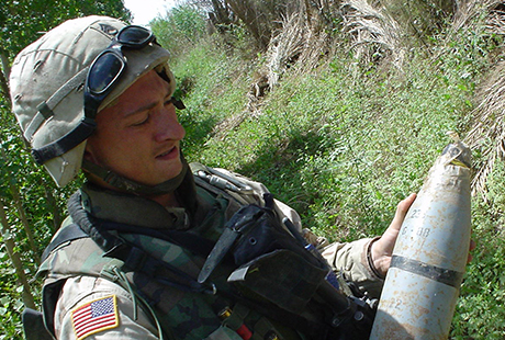 Staff Sgt. David Bellavia handles an improvised explosive device found on a patrol in Muqdadiyah Iraq, March 2004. (Photo courtesy of David Bellavia)